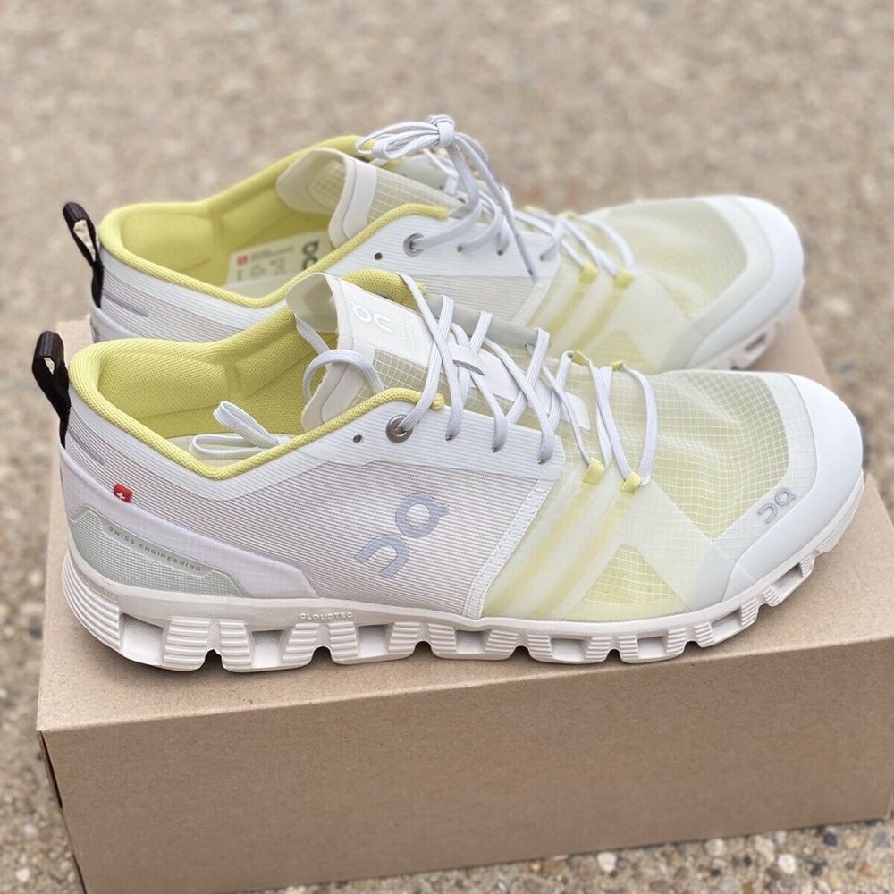 On Running White and Yellow Athletic Shoes